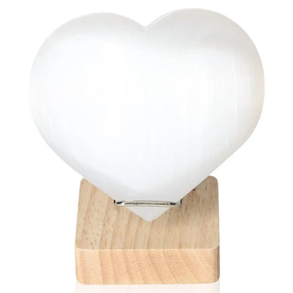 Selenite heart sculpture 12cm on wooden stand by Sylvia Crystals, promoting mindfulness and spiritual growth.