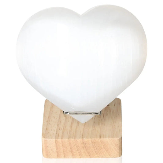Selenite heart sculpture 12cm on wooden stand by Sylvia Crystals, promoting mindfulness and spiritual growth.