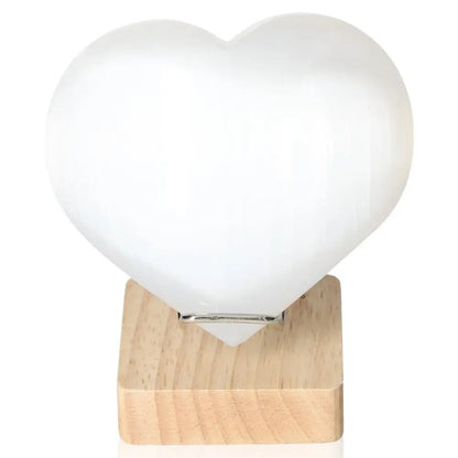 Heart-shaped 12cm Selenite crystal on wooden base by Sylvia Crystals, ideal for spiritual growth and mindful living.