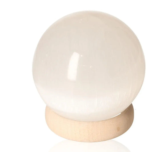 10cm Selenite sphere on wooden stand for spiritual growth and mindful living by Sylvia Crystals, ethically sourced and premium quality.