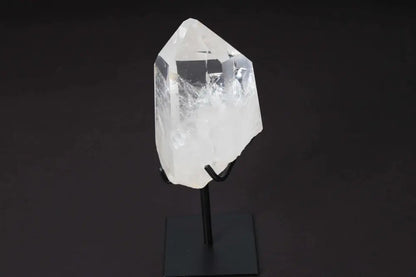 Semi-polished clear quartz point on stand, enhances energy and clarity, ideal for meditation and manifestation.
