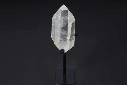 Semi polished clear quartz point on a stand for energy amplification and alignment.