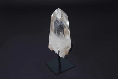 Semi polished clear quartz point with modern stand, amplifying energy for meditation and clarity. Elegant centerpiece for any space.