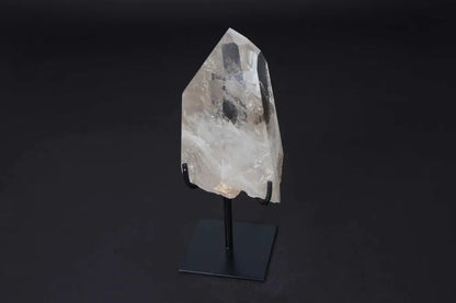 Semi polished clear quartz point with stand, ideal for amplifying energy, meditation, and enhancing clarity. Elegantly displayed on modern stand.