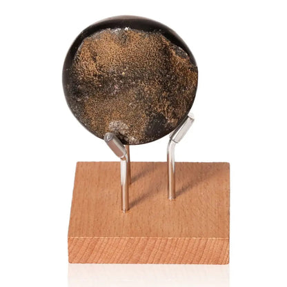 Septarian "Dragon Stone" on wooden stand, showcasing unique mineral patterns and symbolic power, endurance.