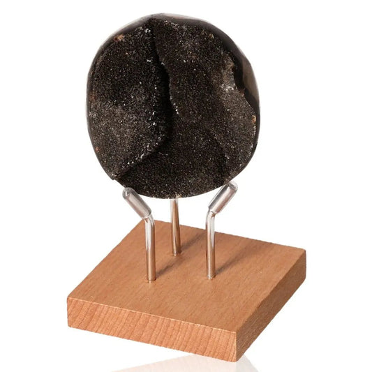 Septarian "Dragon Stone" mineral on wooden base, symbolizing power and endurance, with multidimensional physical and spiritual properties.