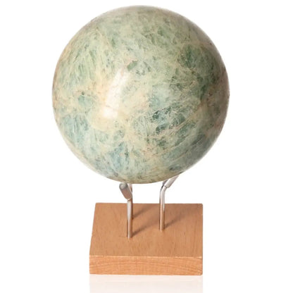 Serpentine Sphere on wooden stand, featuring green hues and a polished finish, highlighting the blend of serpentine and aquamarine energies.