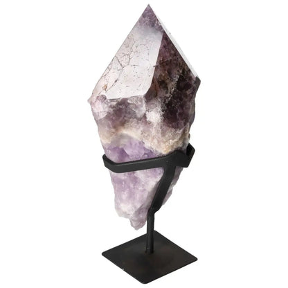 Seven Point Polished Amethyst from Sylvia Crystals, a luxurious crystal for stress relief and mindful living, on display stand.
