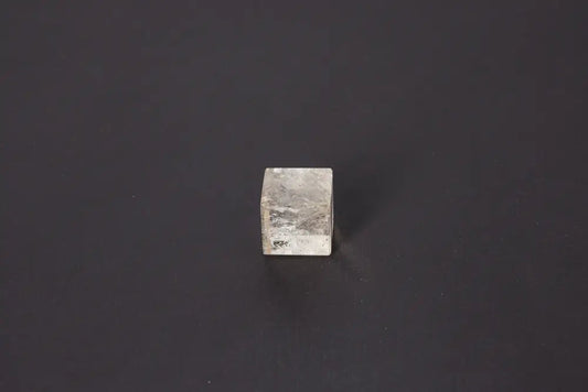 Smoky Quartz Cube 3 cm on black background, showcasing its grounding energy and translucent gray-brown tones for stability and protection.