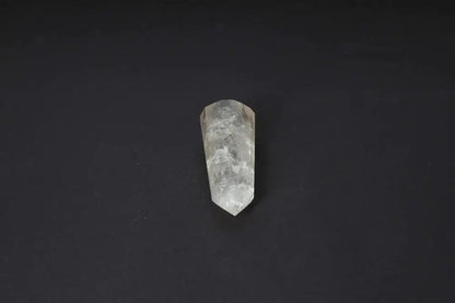 Smoky Quartz Point crystal on dark background, showcasing its translucent warm tones and polished surface for grounding and protection.