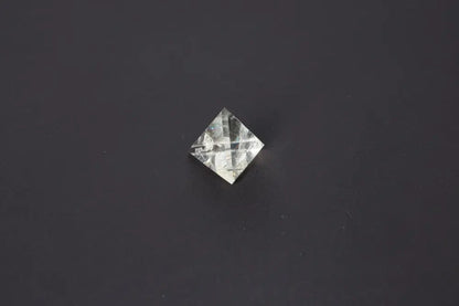 Smoky Quartz Pyramid 4 cm on a dark background showcasing its translucent tones for grounding energy and protection.