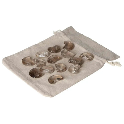 Small smoky quartz moon stones on a fabric pouch, ideal for decision-making support and grounding practical thinking.