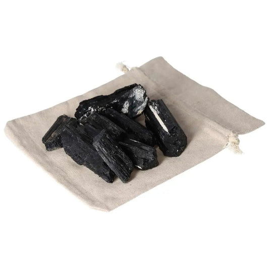 Black Tourmaline stones 1KG, 10 pieces on a beige cloth bag, ideal for cleansing negative energy and grounding, enhances root chakra balance.