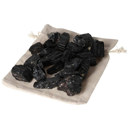 Set of black Tourmaline pieces on a beige drawstring bag from Sylvia Crystals.