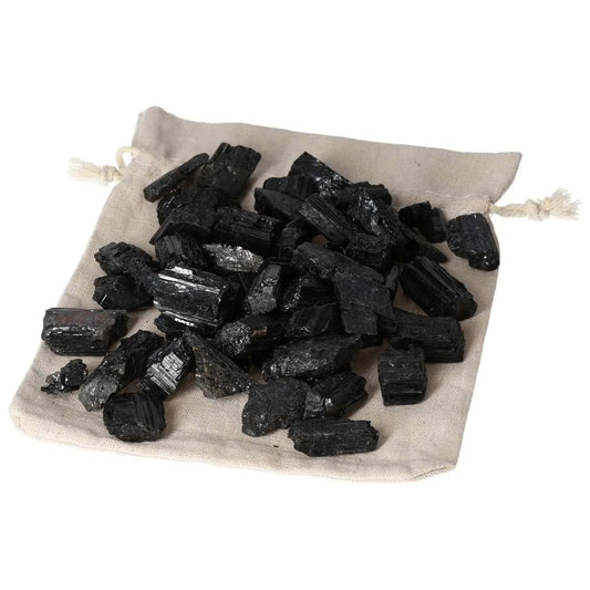 Tourmaline S 1 kg 80 pcs - Black prismatic crystals on beige bag, versatile gemstone for balancing energies.