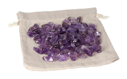Loose tumbled amethyst stones on a cloth bag for stress reduction, energy boost, and emotional stability.