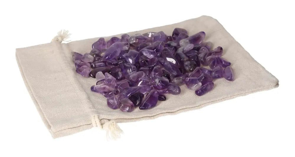 Tumbled Amethyst stones in a linen pouch for stress relief and energy boost, enhancing concentration and emotional stability.
