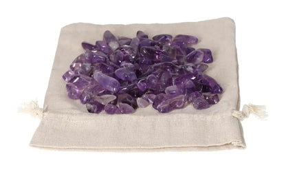 Tumbled Amethyst stones on a beige pouch, offering stress reduction, energy boost, and emotional stability benefits.