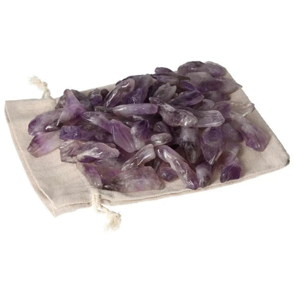 Assorted tumbled amethyst stones on linen pouch showcasing deep purple hues and white veins, available at Sylvia Crystals.