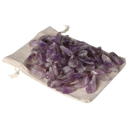 Tumbled Amethyst stones on a linen pouch, showcasing deep purple hues and white veins, ideal for stress relief and energy flow.