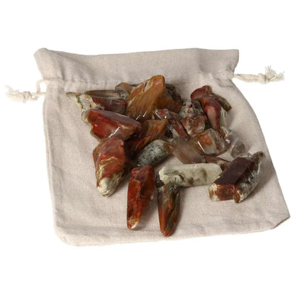 Tumbled Amphibole crystals on linen pouch, part of Sylvia Crystals collection, enhancing spiritual luxury and space beauty.