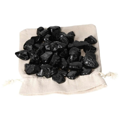 Tumbled Black Tourmaline M stones on a beige bag from Sylvia Crystals.