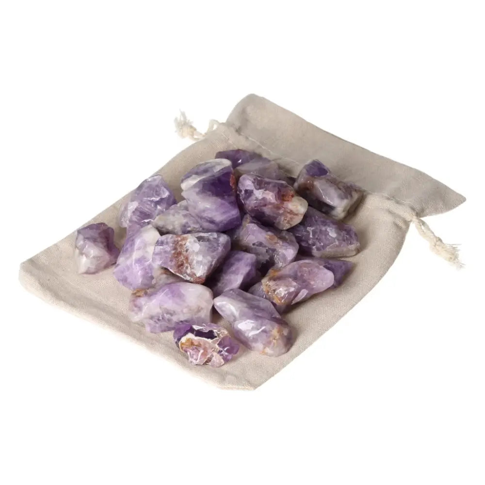 Tumbled Chevron Amethyst stones in a beige pouch, showcasing deep purple and white bands, from Sylvia Crystals.