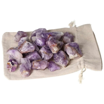 Tumbled Chevron Amethyst stones with deep purple and white bands on a beige sack, from Sylvia Crystals.