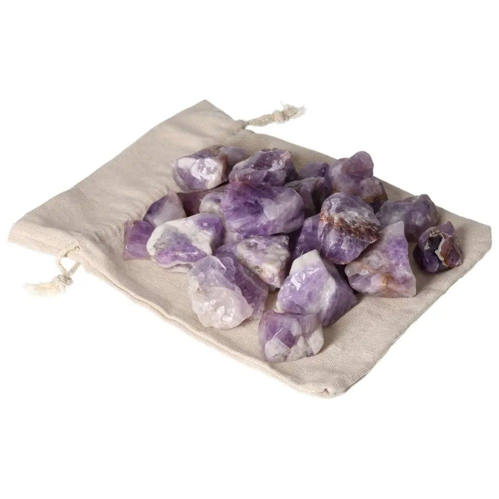 Tumbled Chevron Amethyst stones on a beige cloth bag, featuring deep purple and white bands, from Sylvia Crystals collection.