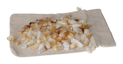 Tumbled Citrine and Quartz stones on cloth pouch, promoting inspiration and abundance, ideal for new ventures and positive energy.