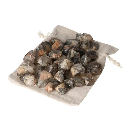 Tumbled Lodolite gemstones on a beige pouch, premium crystals for inner peace from Sylvia Crystals, conscious luxury brand.