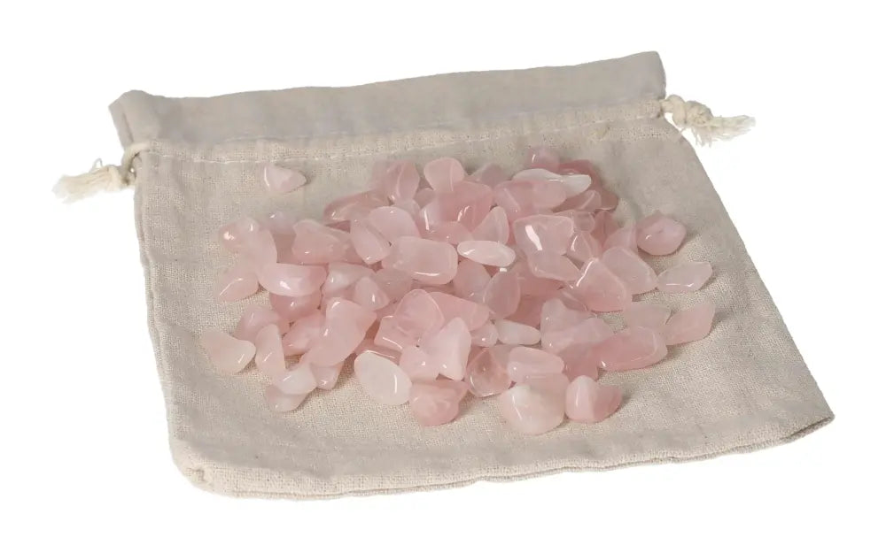 Tumbled Rose Quartz stones on a drawstring bag, symbolizing love and emotional healing with gentle pink hues.