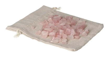Tumbled Rose Quartz stones on a fabric pouch, symbolizing love and healing with gentle, calming energy.