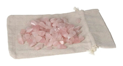 Tumbled Rose Quartz stones on a beige cloth bag, symbolizing love and emotional healing energy.