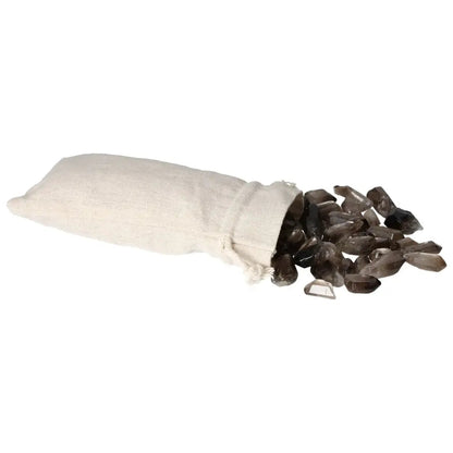 A linen pouch spilling tumbled smoky quartz points, highlighting their polished surfaces and color variations, from Sylvia Crystals.