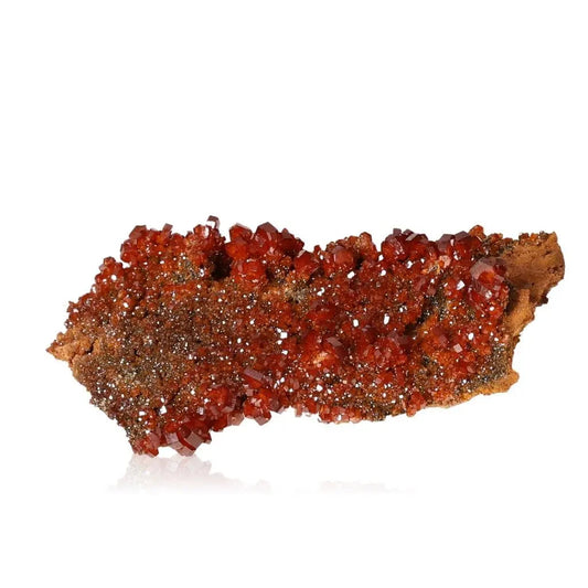 Vibrant red-orange Vanadinite druzy crystal showcasing unique formations and grounding properties for focus and creativity enhancement.