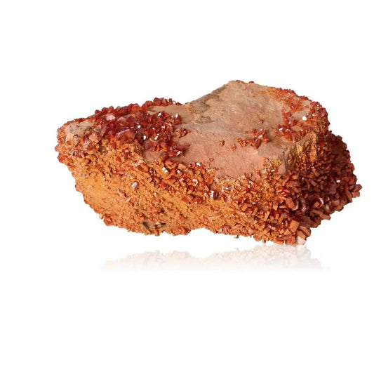 Vibrant Vanadinite crystal druze with fiery red-orange hues, perfect for enhancing focus and creativity, on a white background.