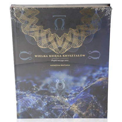 Cover of 'Wielka księga kryształów' by Katarzyna Bratumiła Baran, featuring mystical blue crystals and intricate gold patterns.