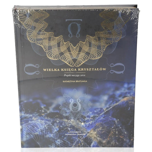 Cover of 'Wielka księga kryształów' by Katarzyna Bratumiła Baran, featuring mystical blue crystals and intricate gold patterns.