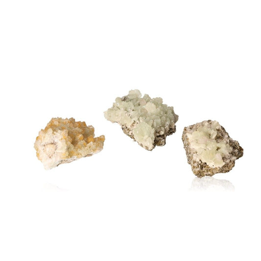 Three pieces of prehnite gemstone in pale green and yellowish-green tones, showcasing their natural crystalline formations.