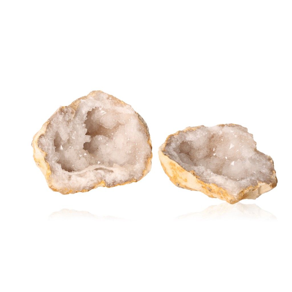 Milky quartz geodes with sparkling white crystals and rugged outer shells, enhancing tranquility and positive energy.