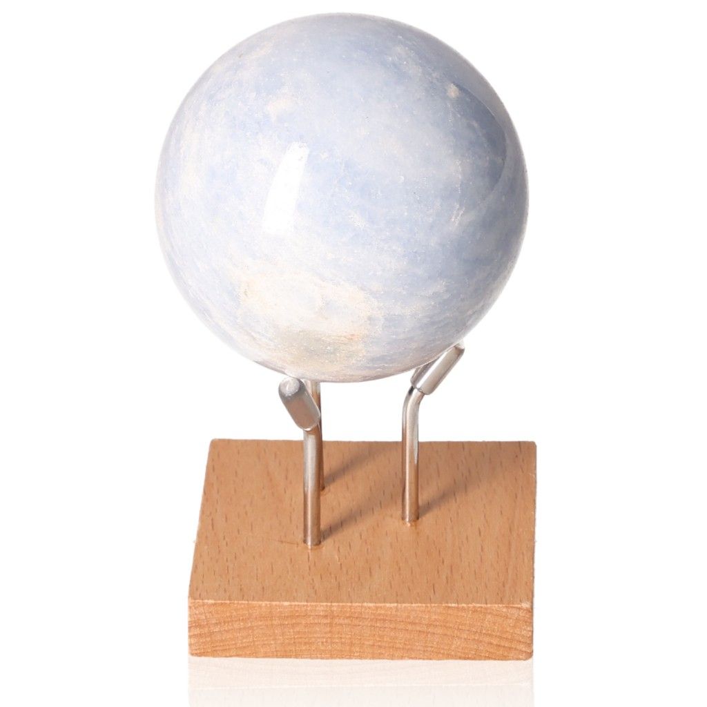 Blue Calcite Sphere for stress relief, communication enhancement, and emotional healing displayed on a wooden stand.