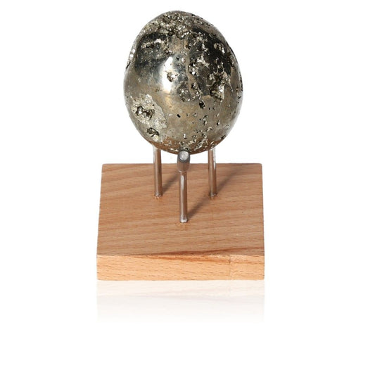 Shiny pyrite egg on a wooden stand, symbolizing courage and initiative, ideal for inspiring new ideas and achieving goals.