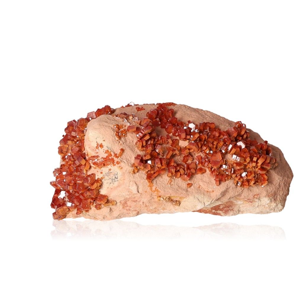 Vanadinite Druze with vibrant hexagonal reddish-brown crystals on a rock, showcasing bold colors and geometric shapes.