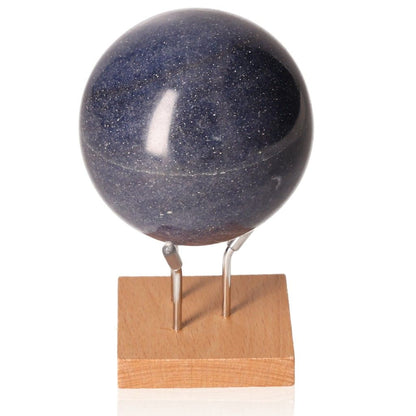 Blue Sandstone Sphere on wooden stand, sparkling glass with copper particles, energizing and motivational gemstone.