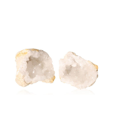 Milky quartz geode pair with rugged exterior and sparkling white crystals, enhancing energy balance and promoting tranquility.