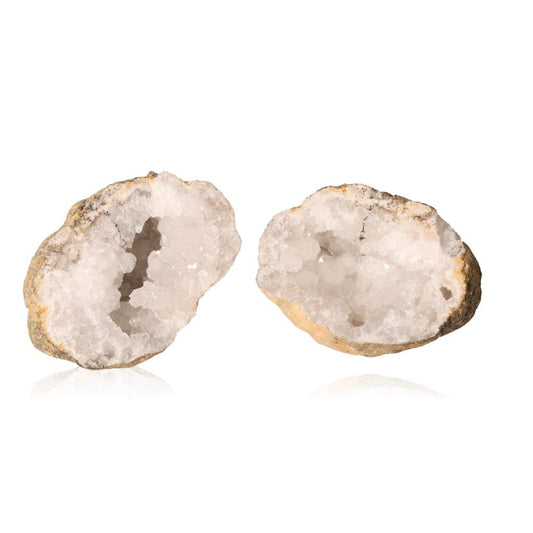 Sparkling milky quartz geode halves with cloudy white crystals, known for purifying energy and enhancing tranquility and focus.