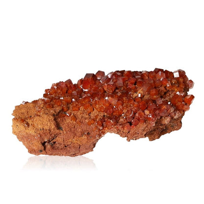 Vanadinite druzy with vibrant reddish-brown hexagonal crystals on a rocky base, ideal for enhancing focus and motivation.