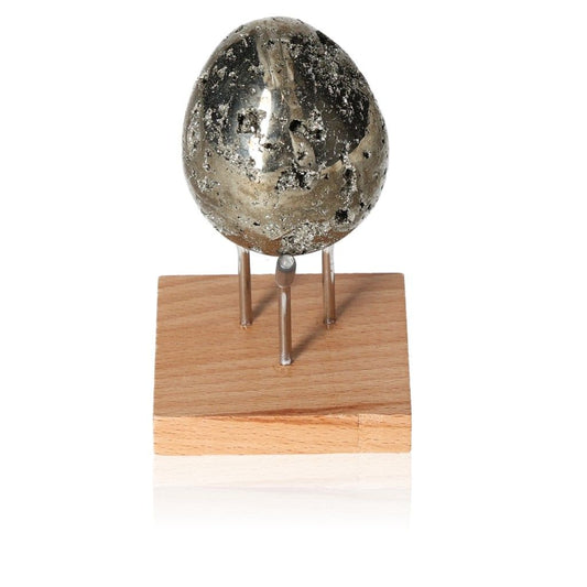 Polished pyrite egg displayed on a wooden stand, symbolizing mental independence and creativity enhancement.