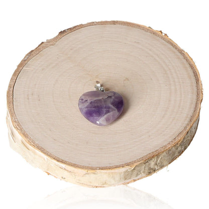 Amethyst heart pendant 20mm on natural wood background for elegant display.